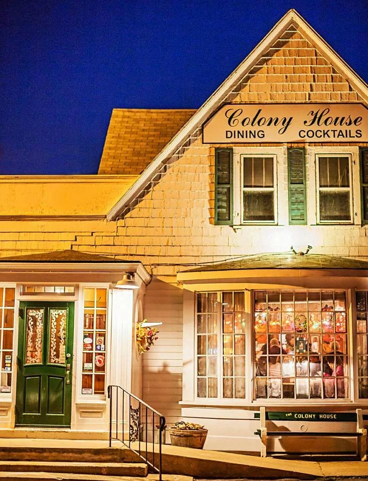 Charming restaurant exterior at night with warm lighting
