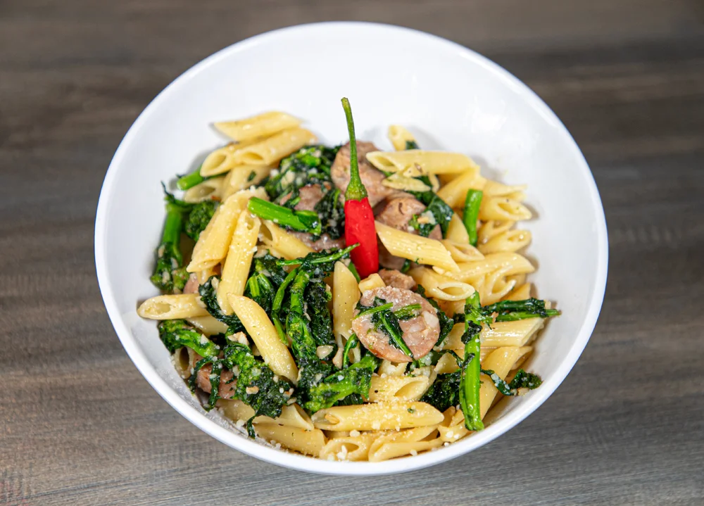 Italian penne pasta with sausage and greens