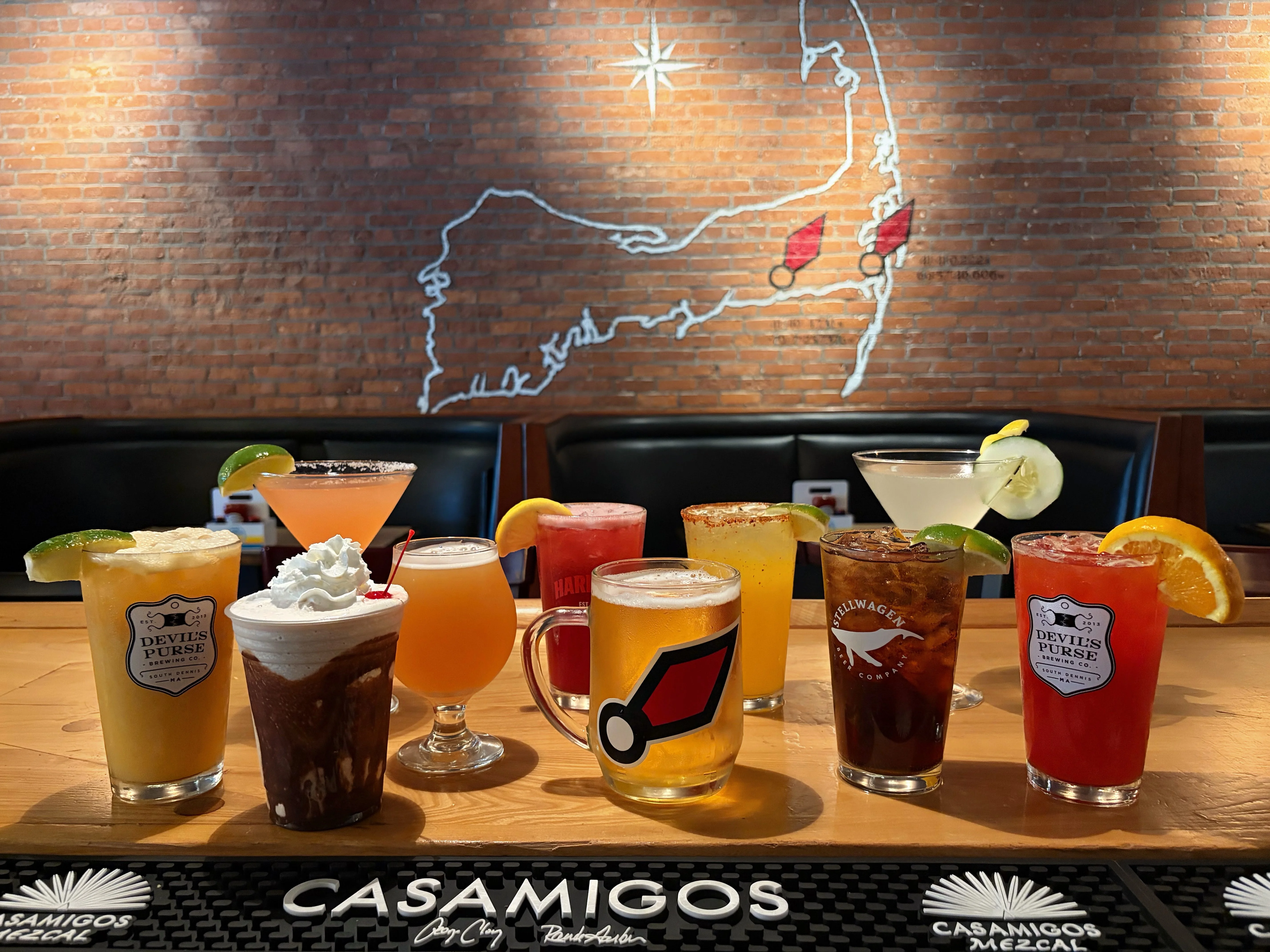 Colorful cocktails displayed on a bar counter in a vibrant restaurant
