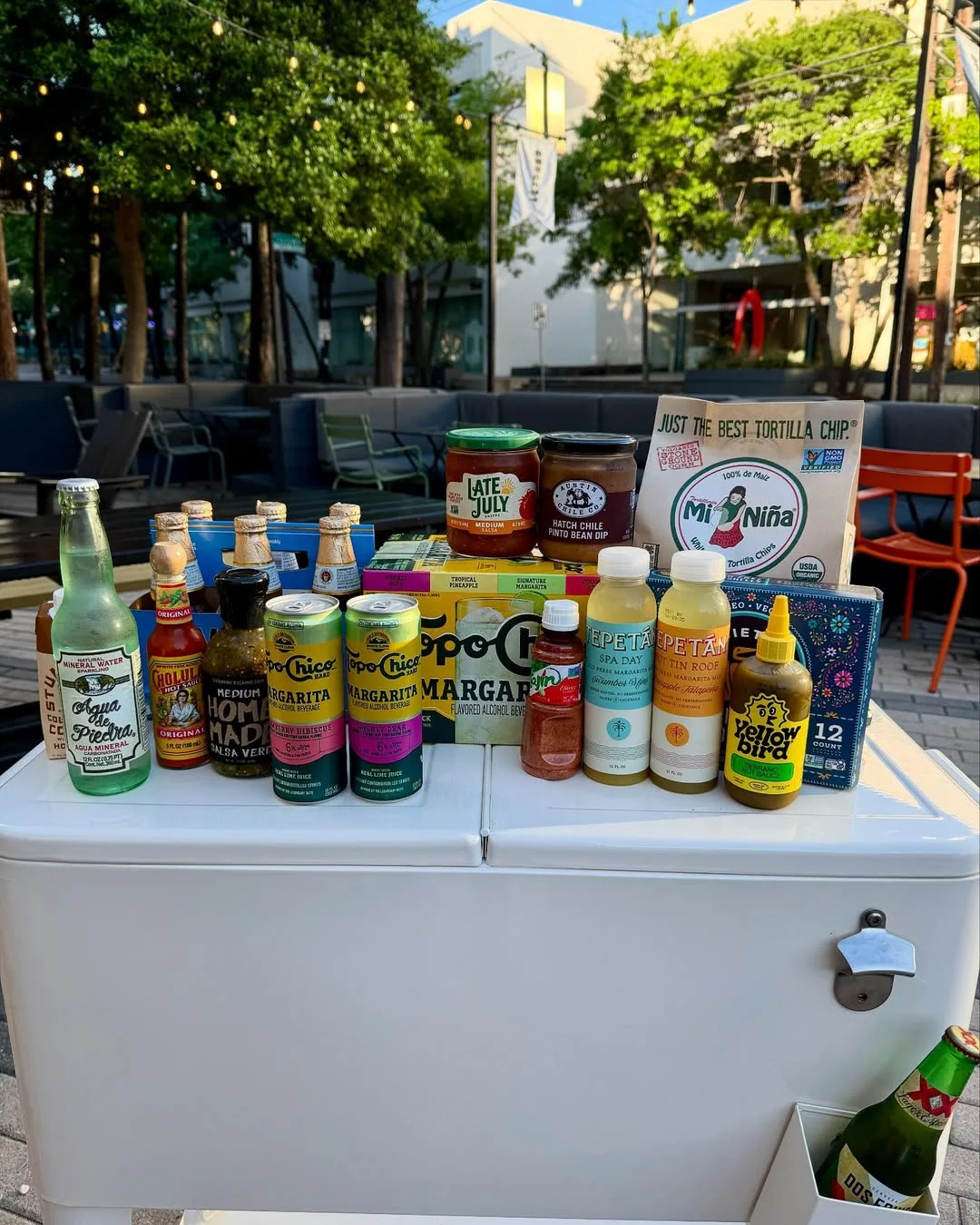 Variety of beverages and snacks displayed outdoors