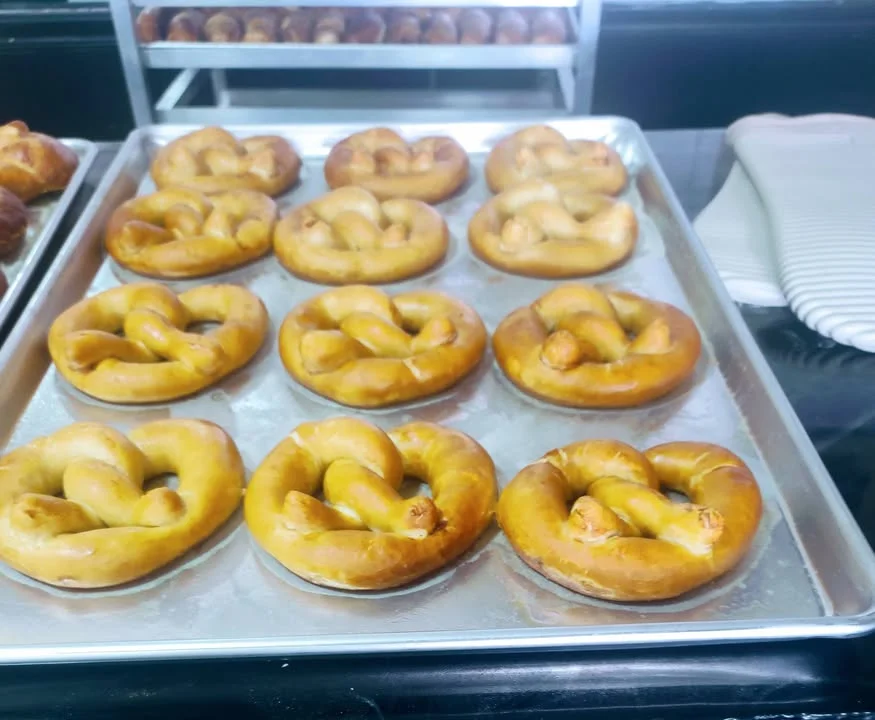 Freshly baked soft pretzels on a tray