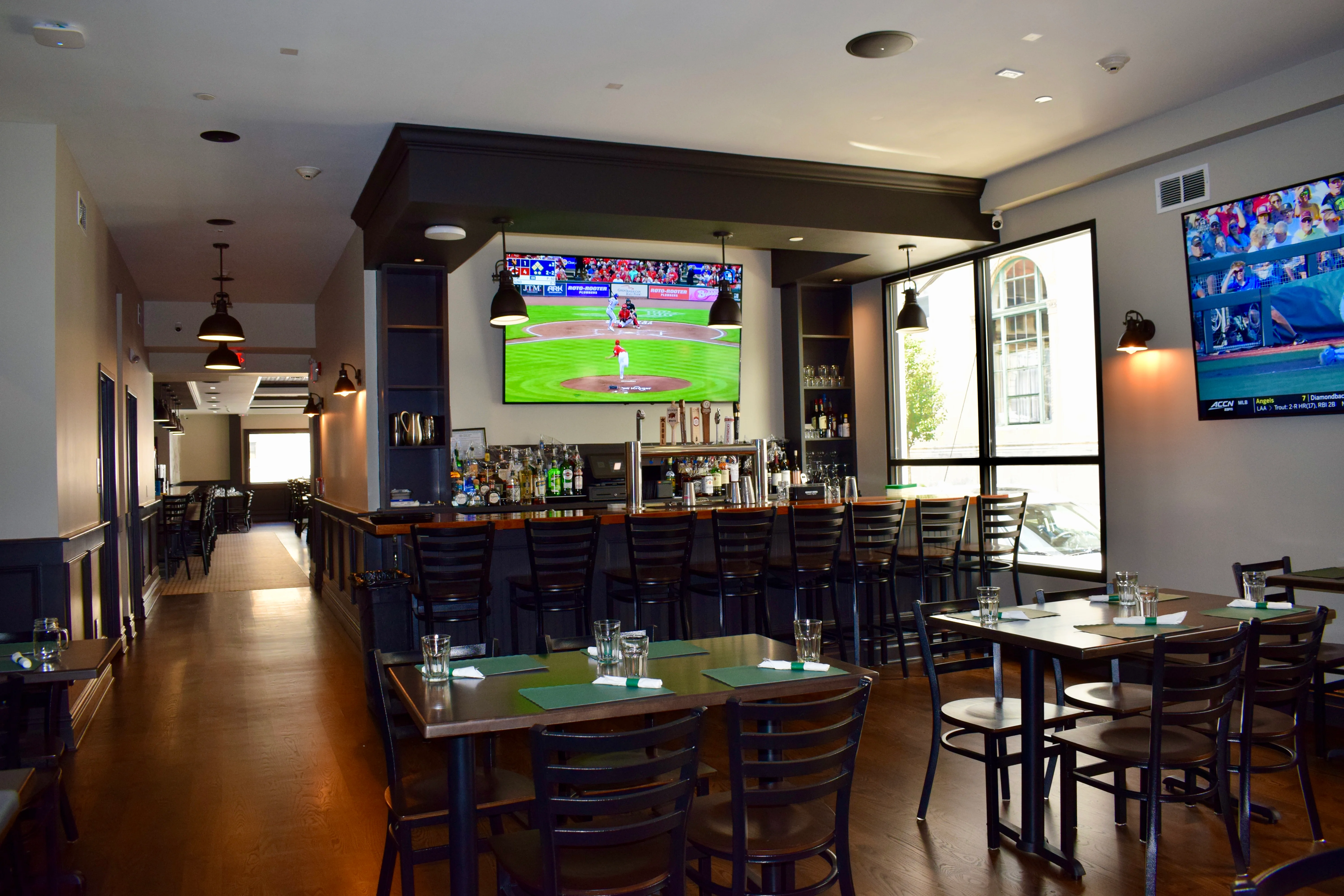 Modern restaurant interior with bar and TVs