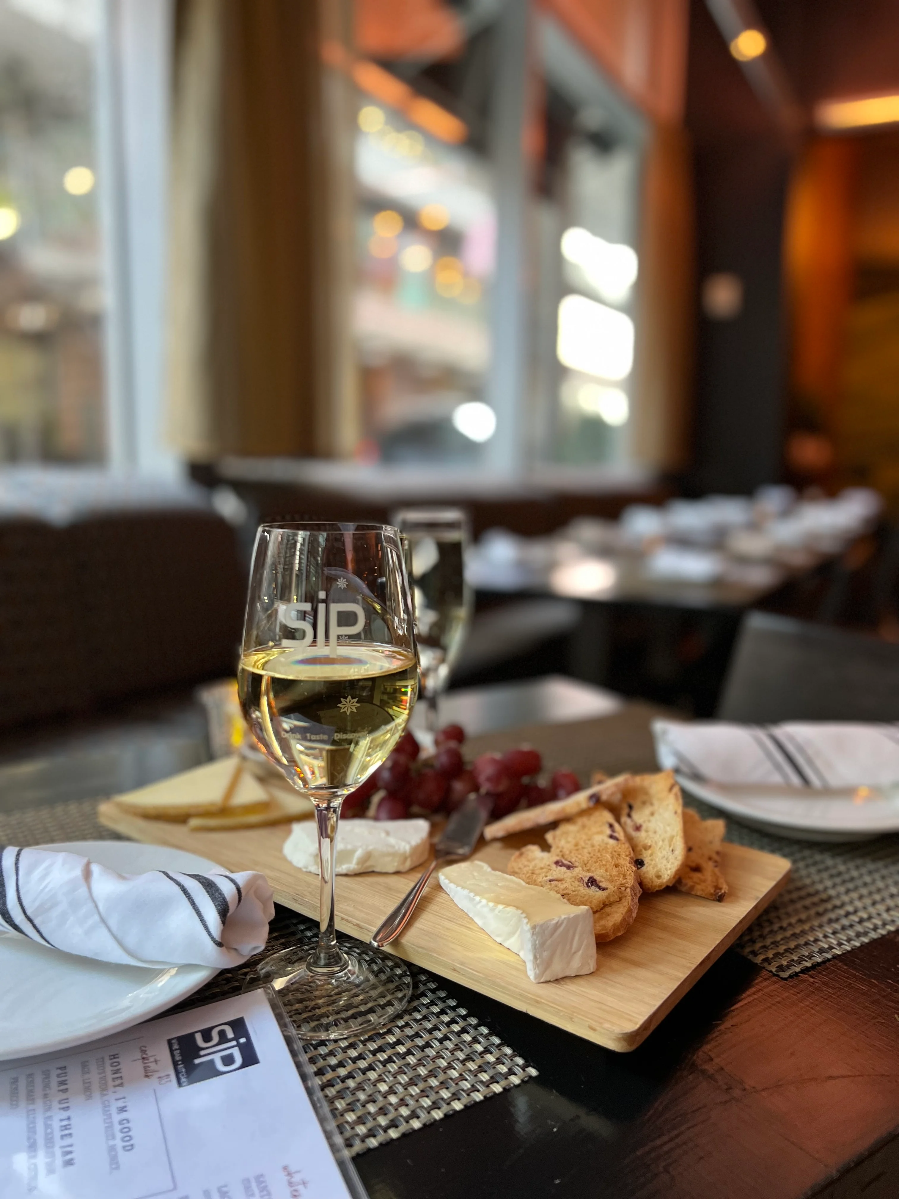 Elegant wine and cheese platter in a cozy restaurant setting