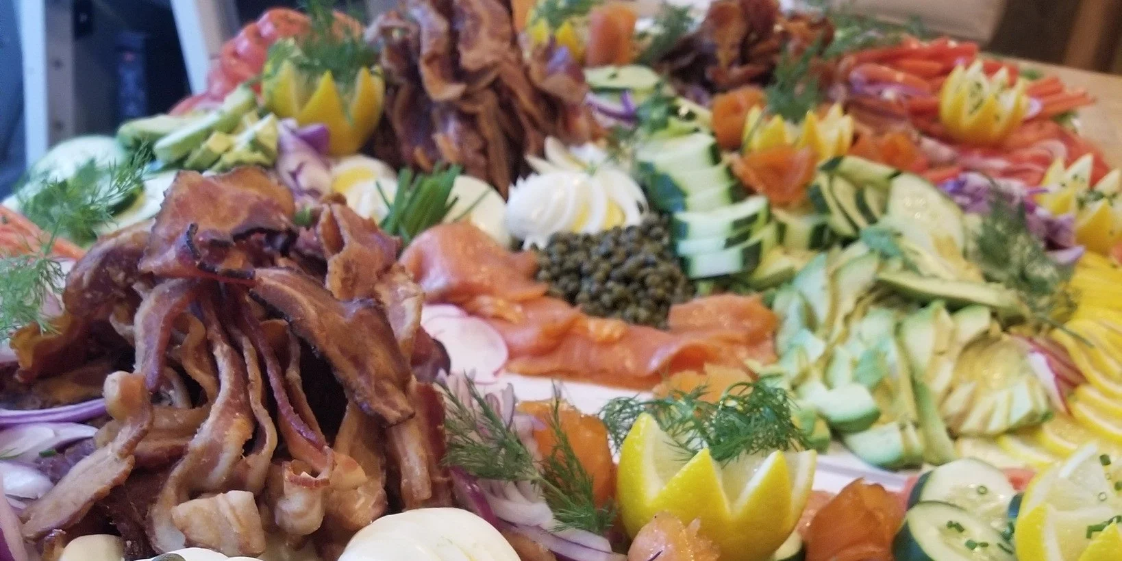 Artisan charcuterie platter with smoked salmon and assorted vegetables