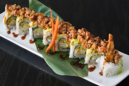 Crispy tempura sushi roll served on a white plate