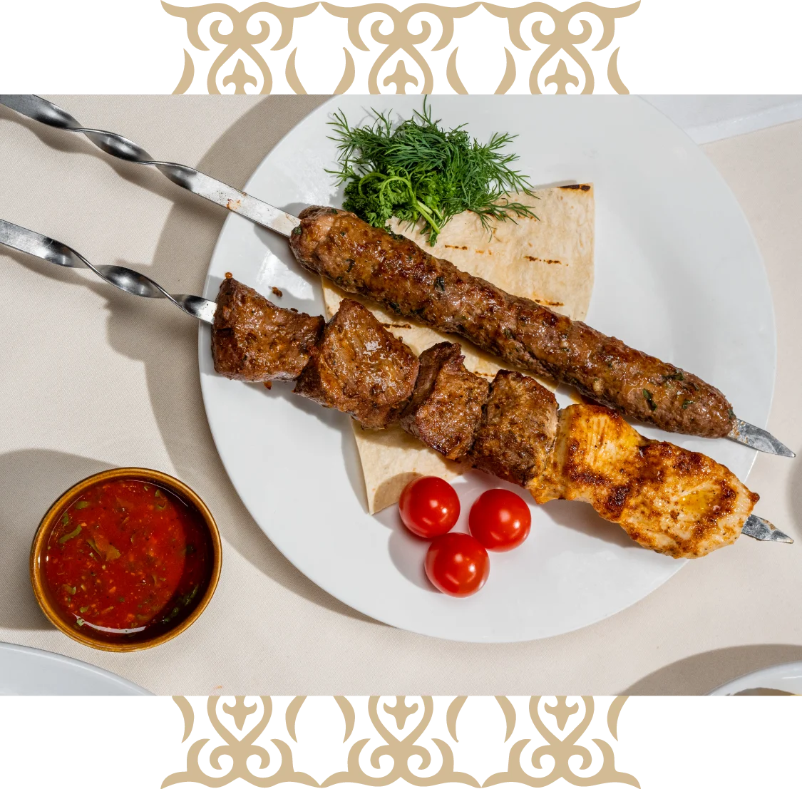 Skewered kebab served with roasted potatoes and dipping sauce