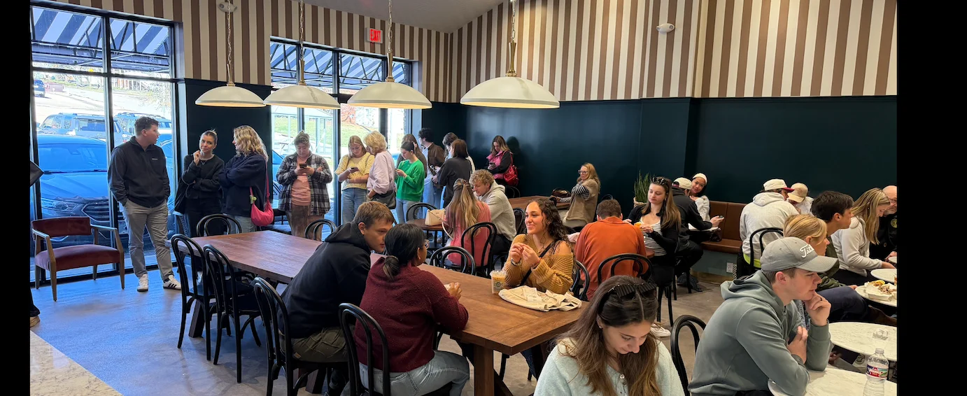 A vibrant restaurant lobby with colorful decor and seating arrangements.