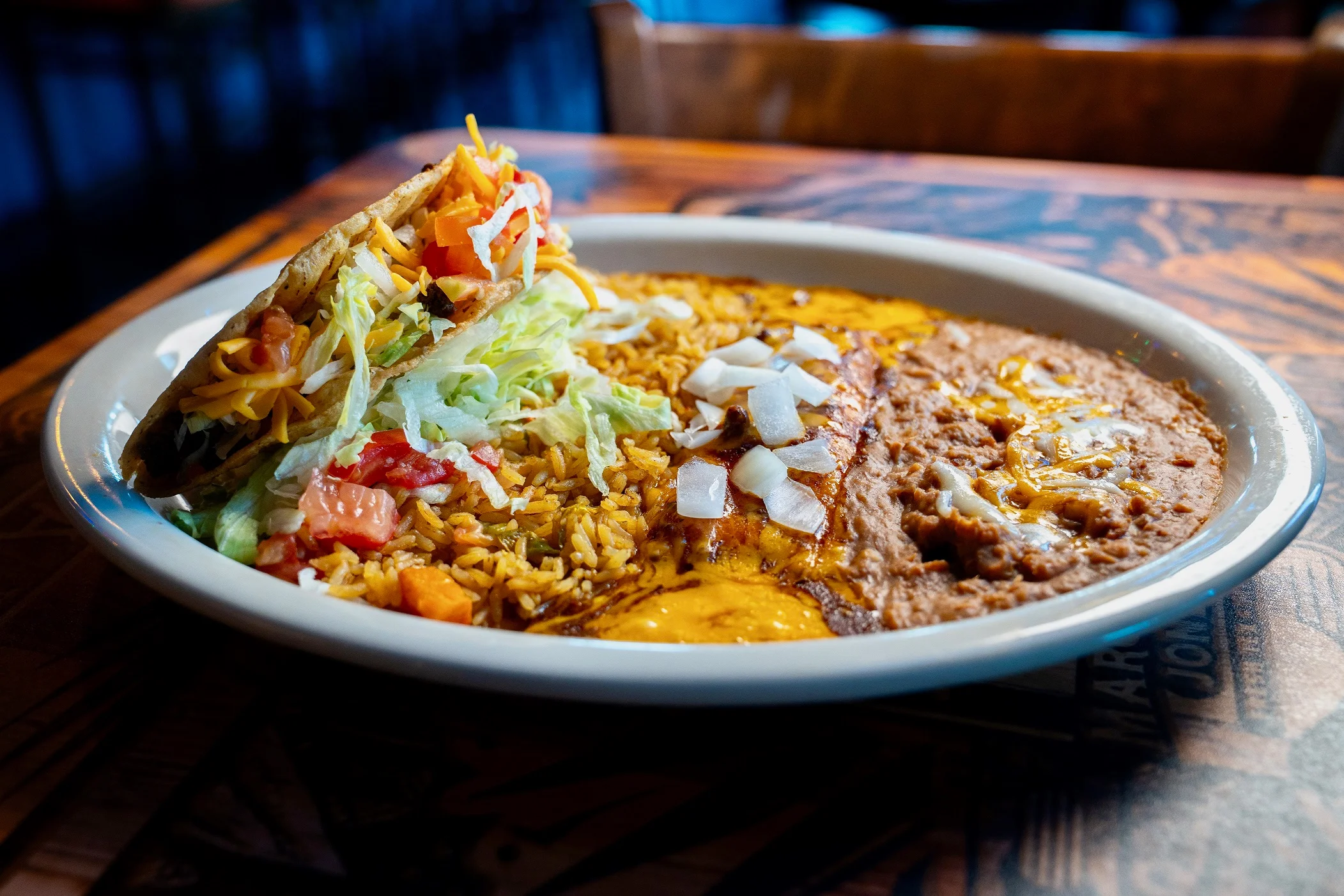 Plate of Mexican enchiladas with rice and taco salad