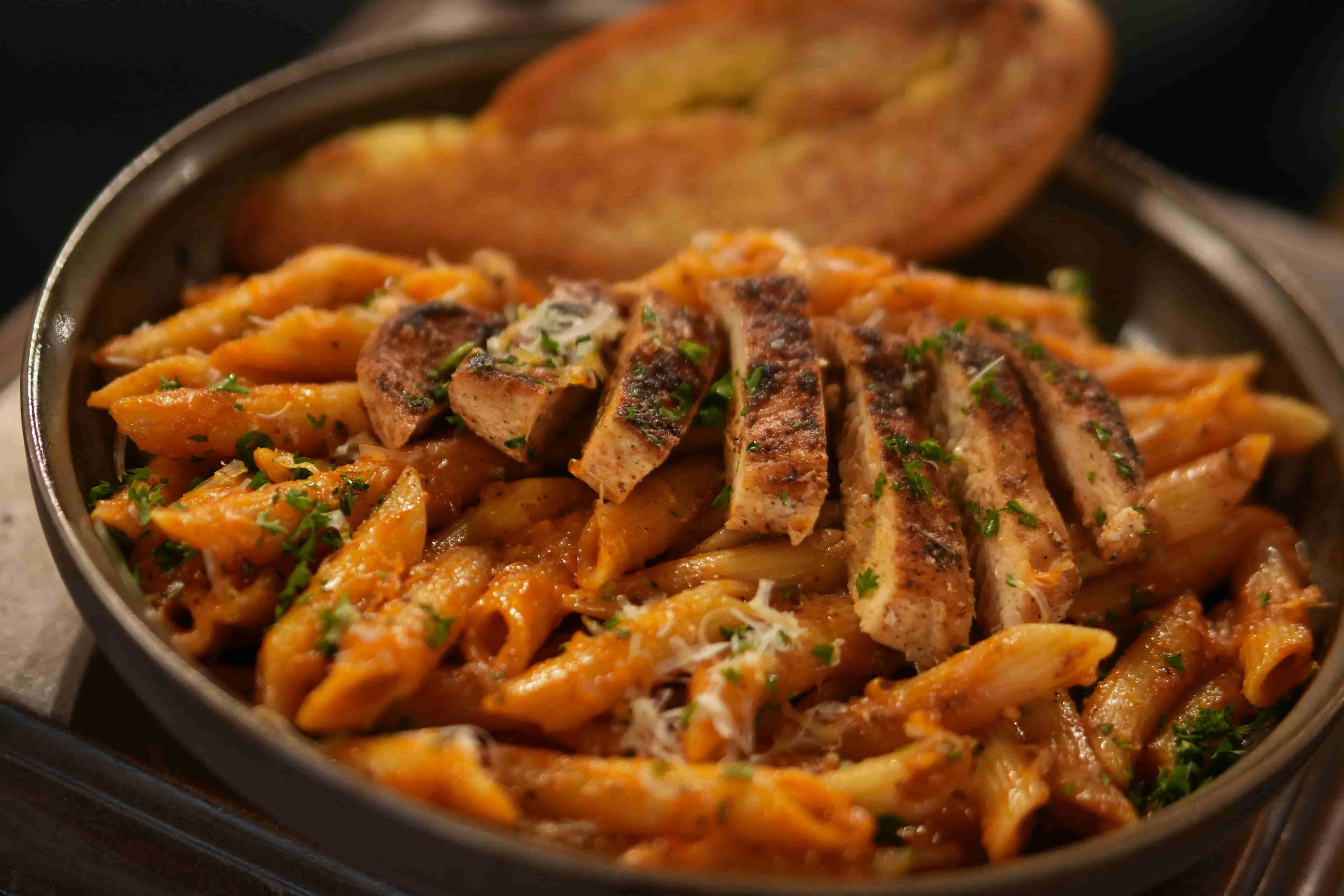 Penne pasta with grilled chicken in a rich tomato sauce