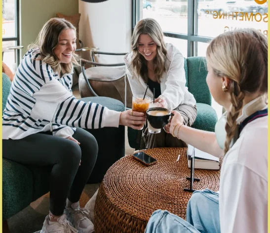 Friends enjoying drinks in a cozy cafe setting