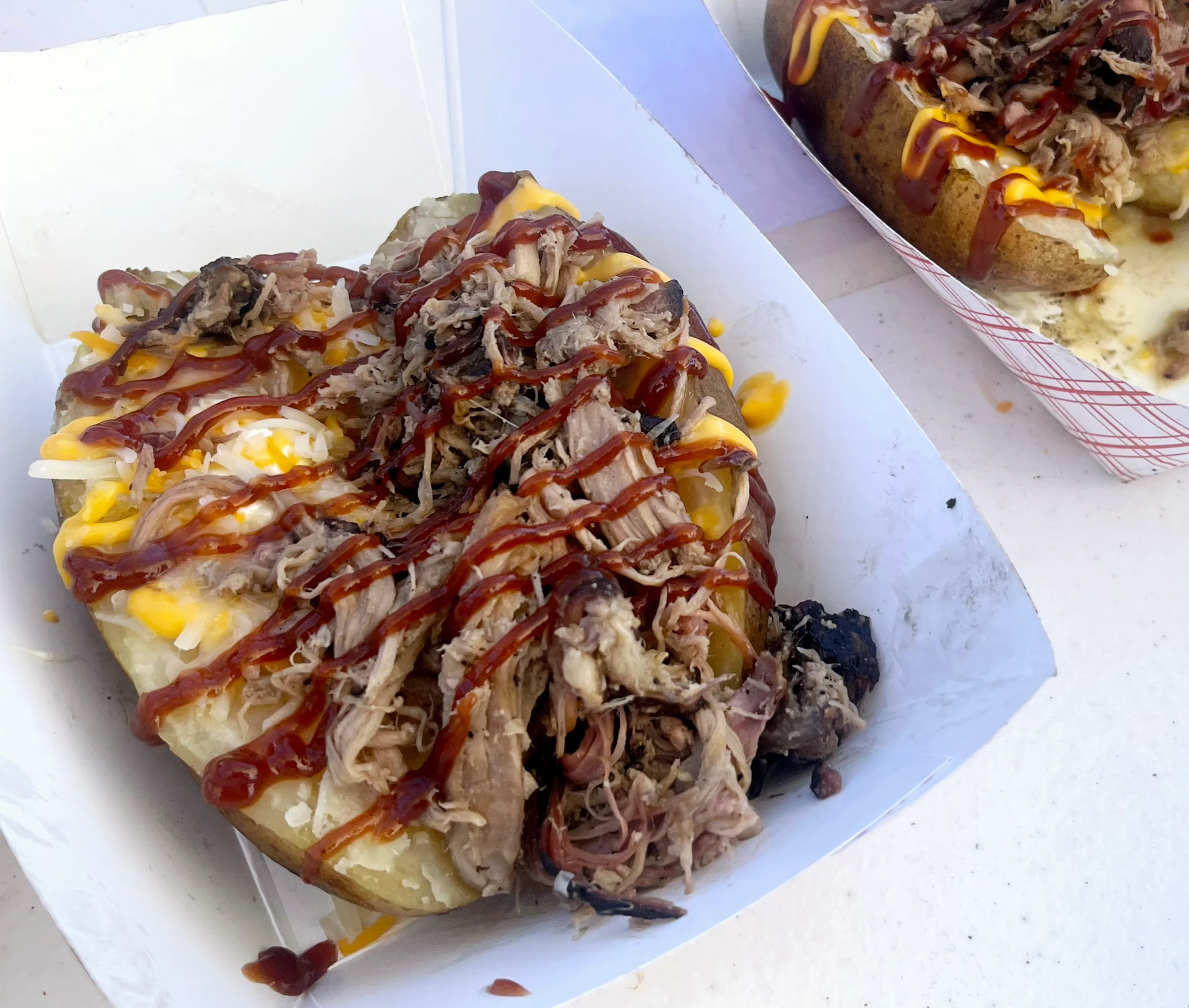 Loaded baked potato with pulled pork and barbecue sauce