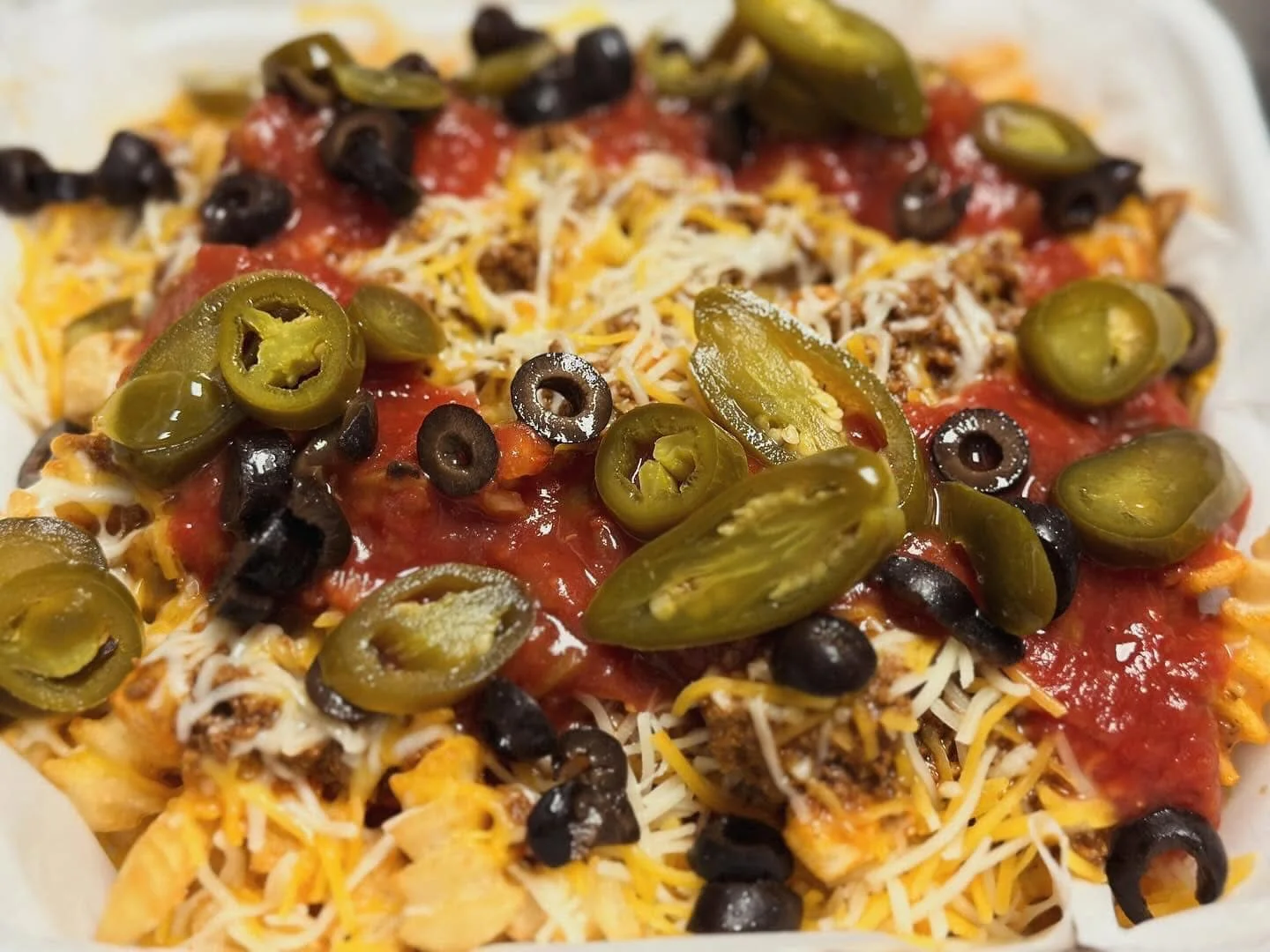 Loaded nachos topped with jalapeños and salsa