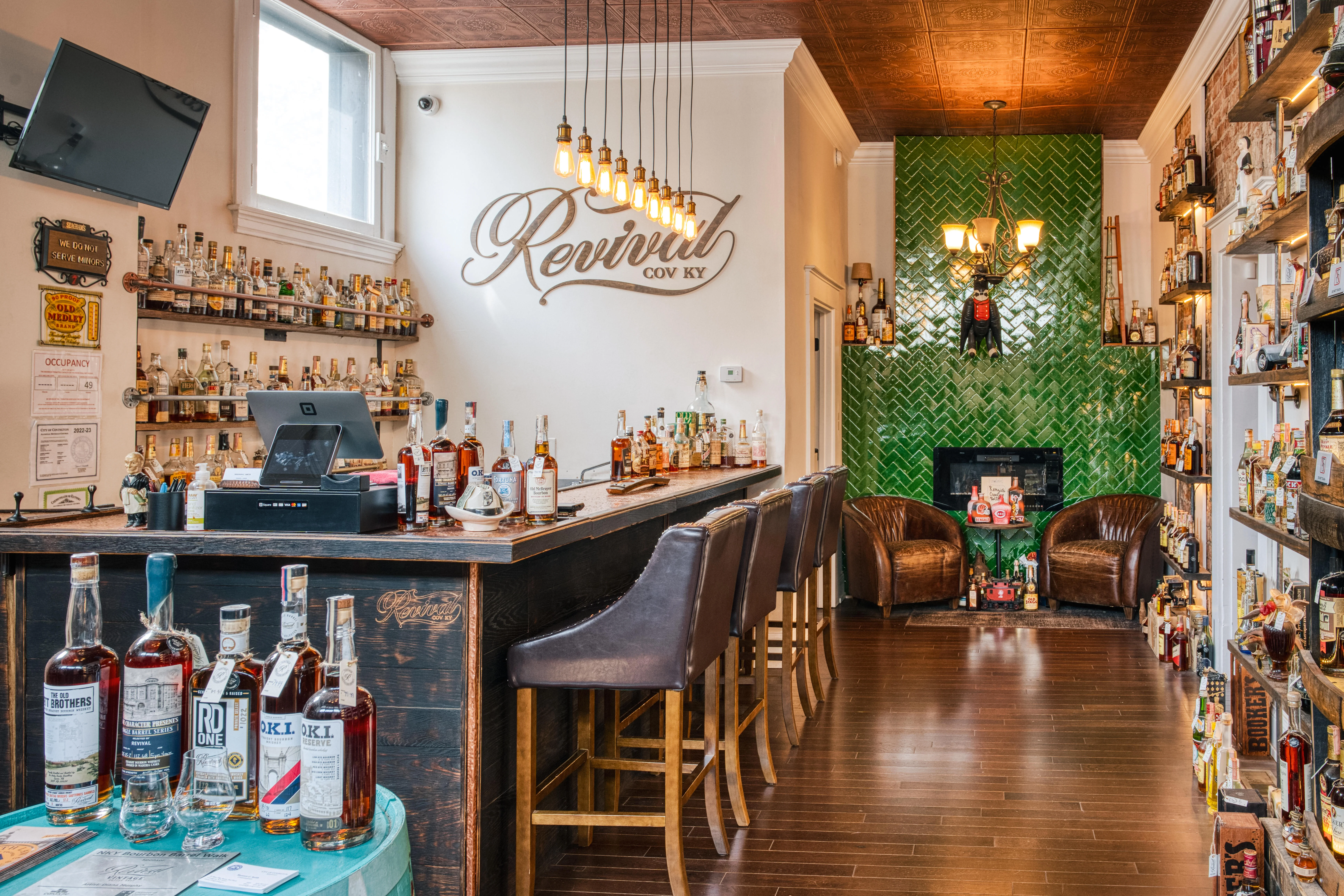 Stylish bar interior with whiskey bottles and cozy seating