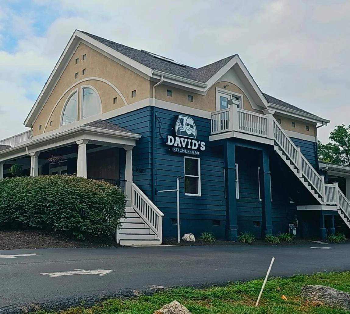Exterior view of David's Kitchen & Bar with signage and landscaping