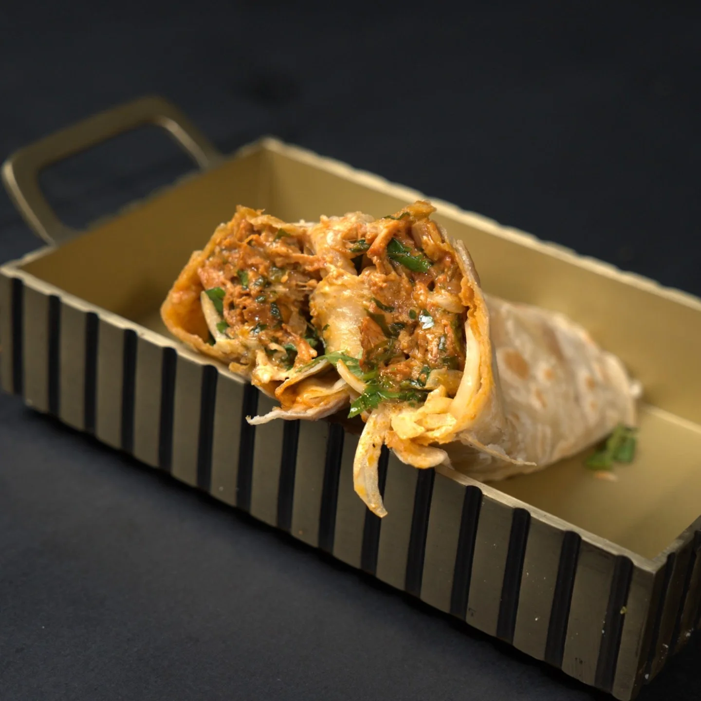 Delicious Indian chicken kathi roll served in a stylish tray
