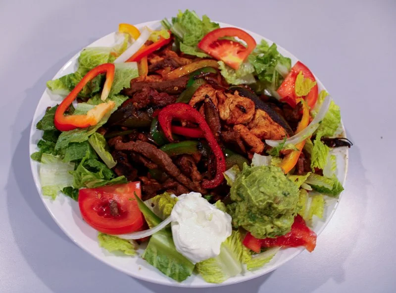 Colorful fajita salad with grilled meats and fresh vegetables