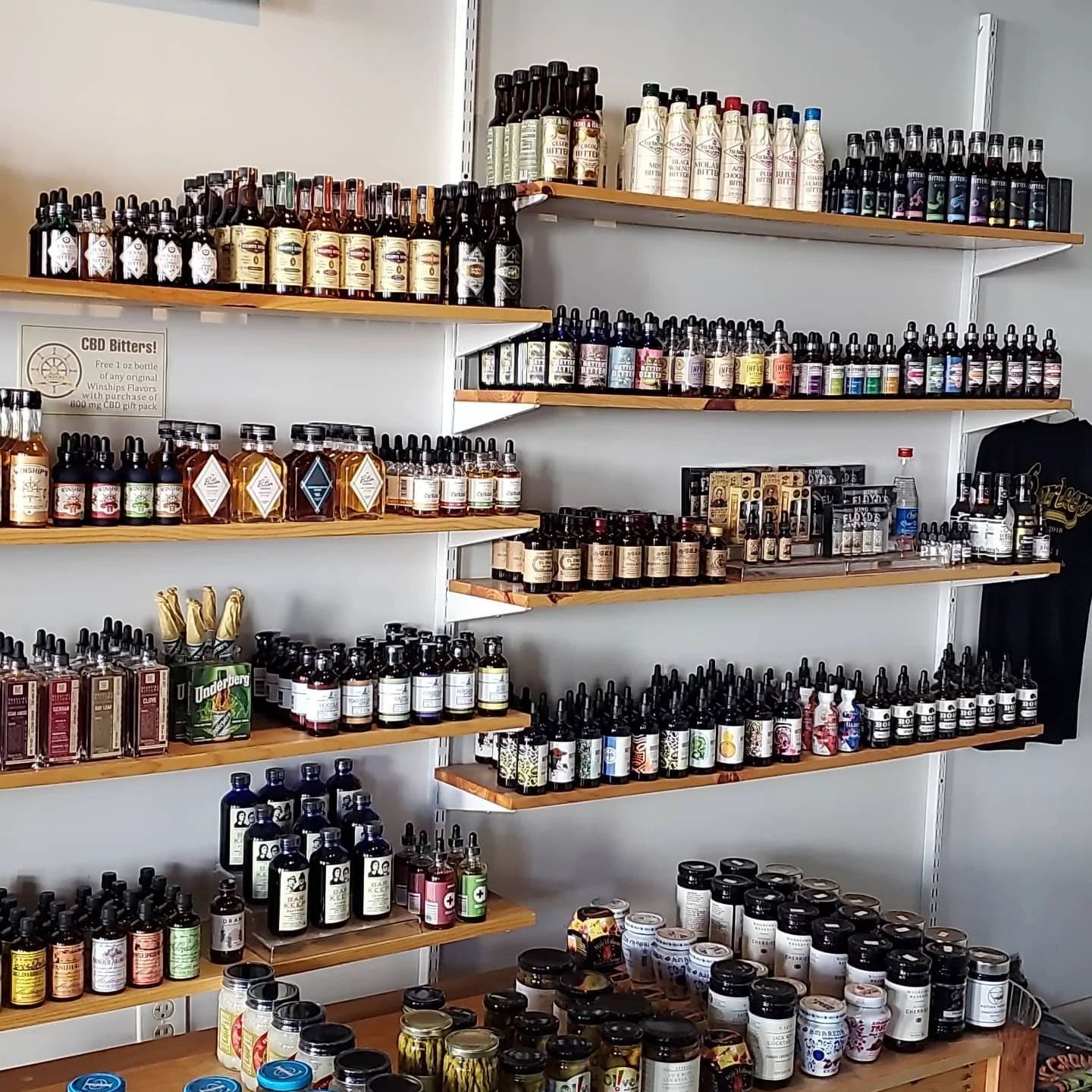 Display of various CBD products on wooden shelves in a retail space