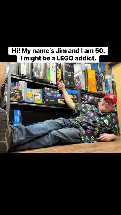 LEGO enthusiast showcasing collection in a playful pose