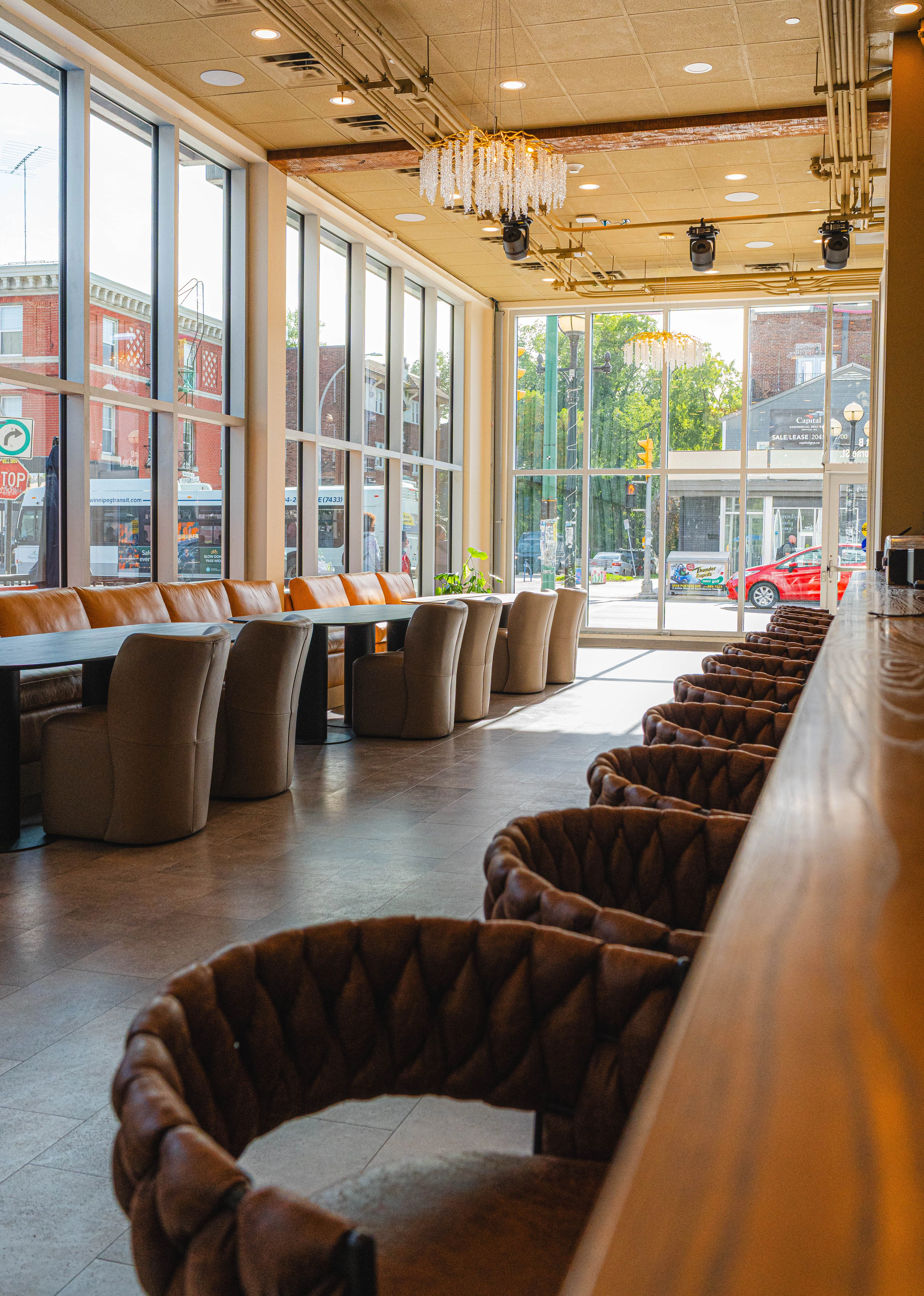 Modern restaurant interior with large windows and stylish seating