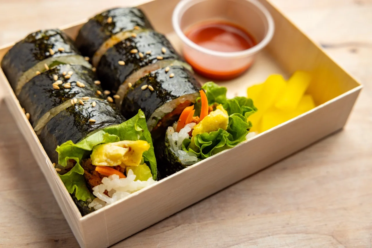 Korean gimbap rolls with vegetables and dipping sauce