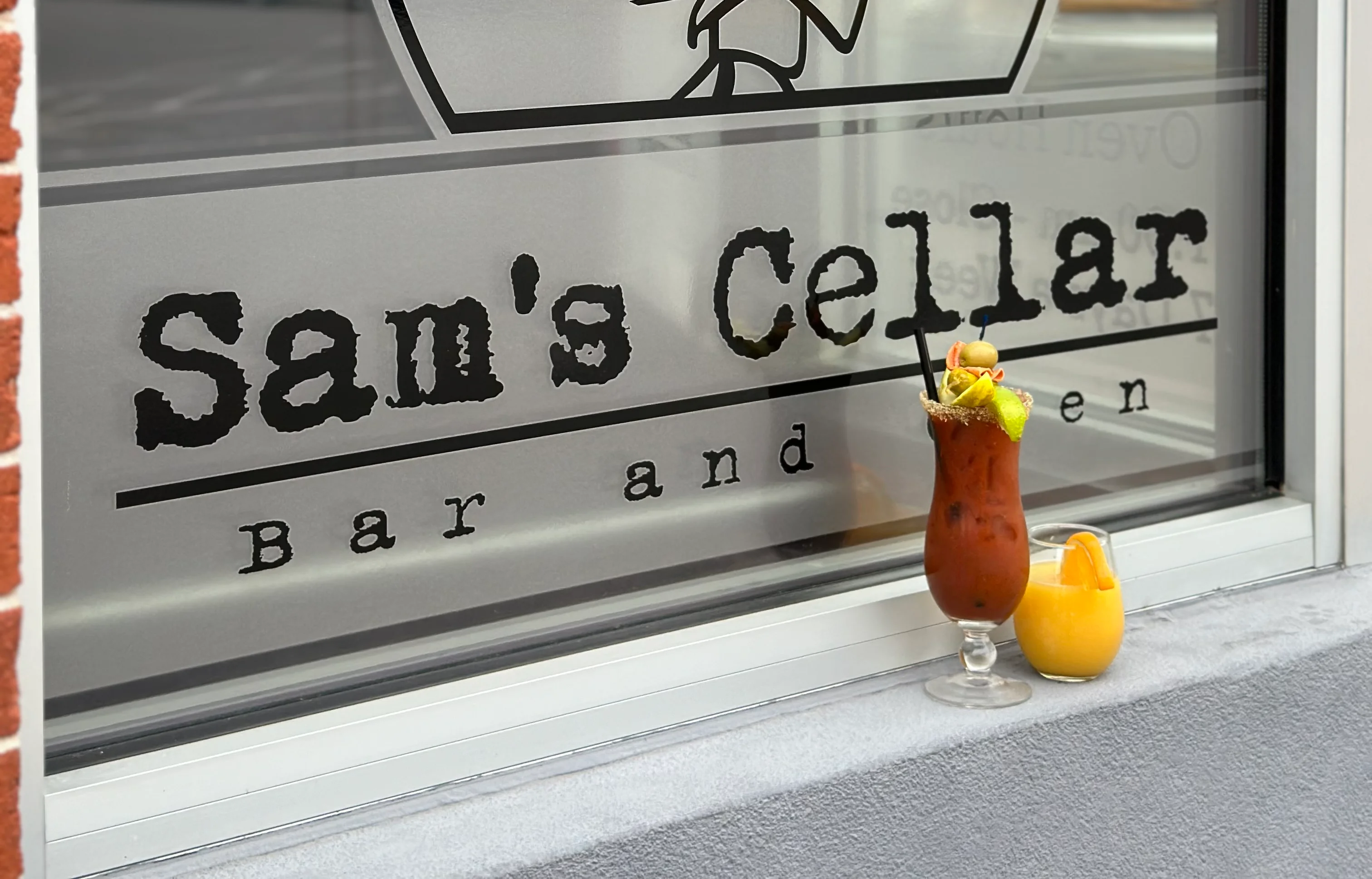 Cocktails at Sam's Cellar Bar and Grill with a playful logo