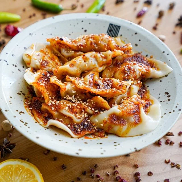 Dumplings with spicy sweet sauce on a plate