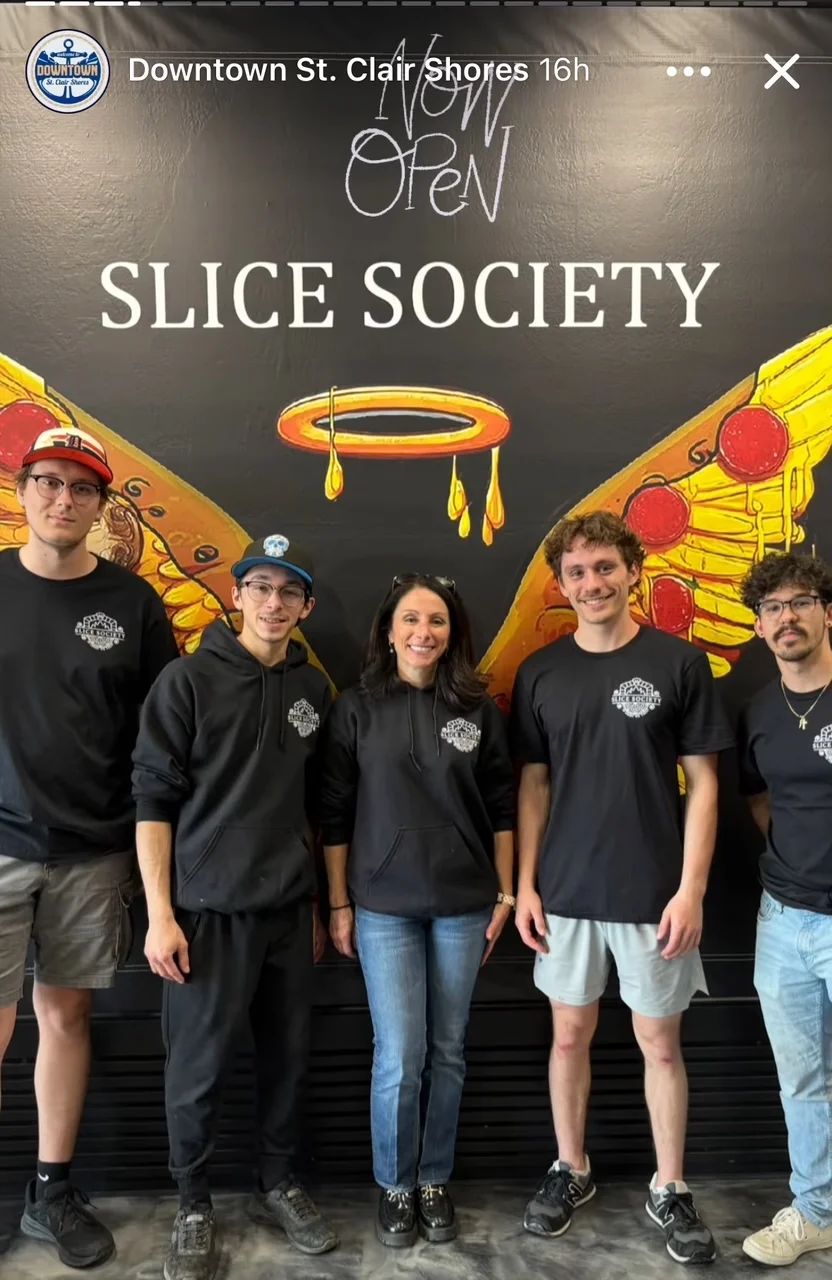 Team members celebrating the opening of Slice Society restaurant