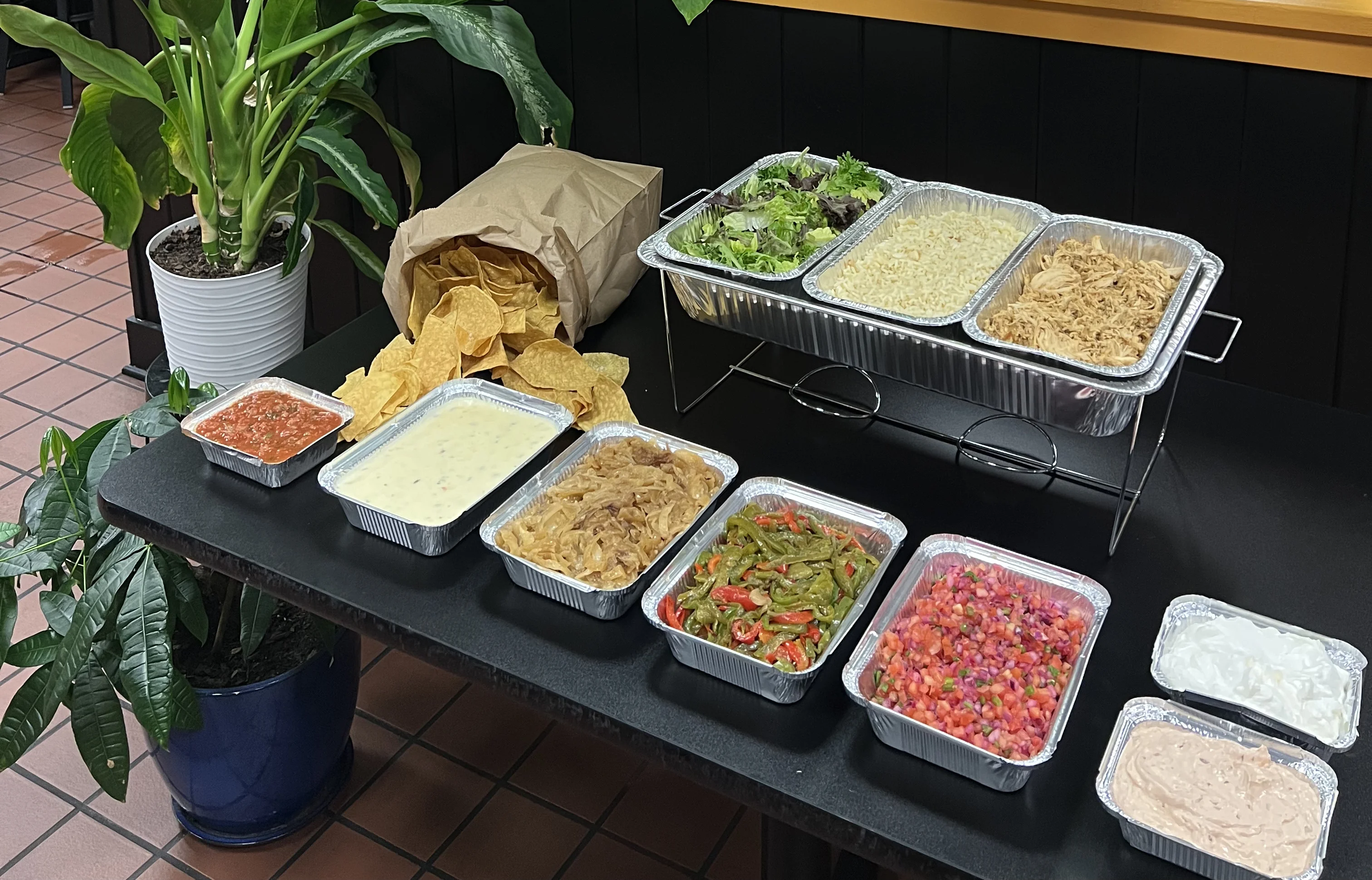 Colorful Mexican buffet with various dishes and fresh toppings
