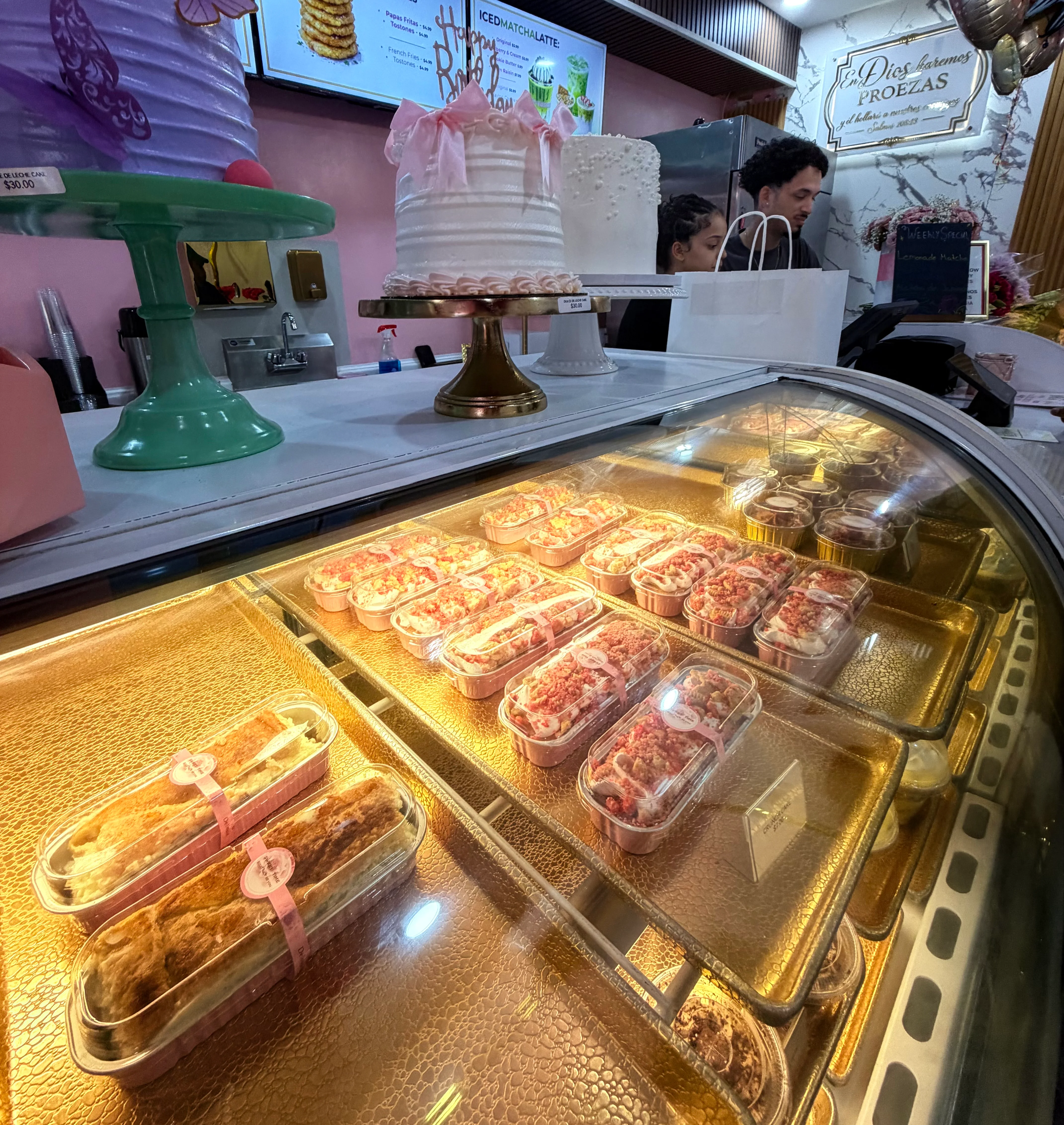 Display of colorful desserts and cakes in a bakery showcase