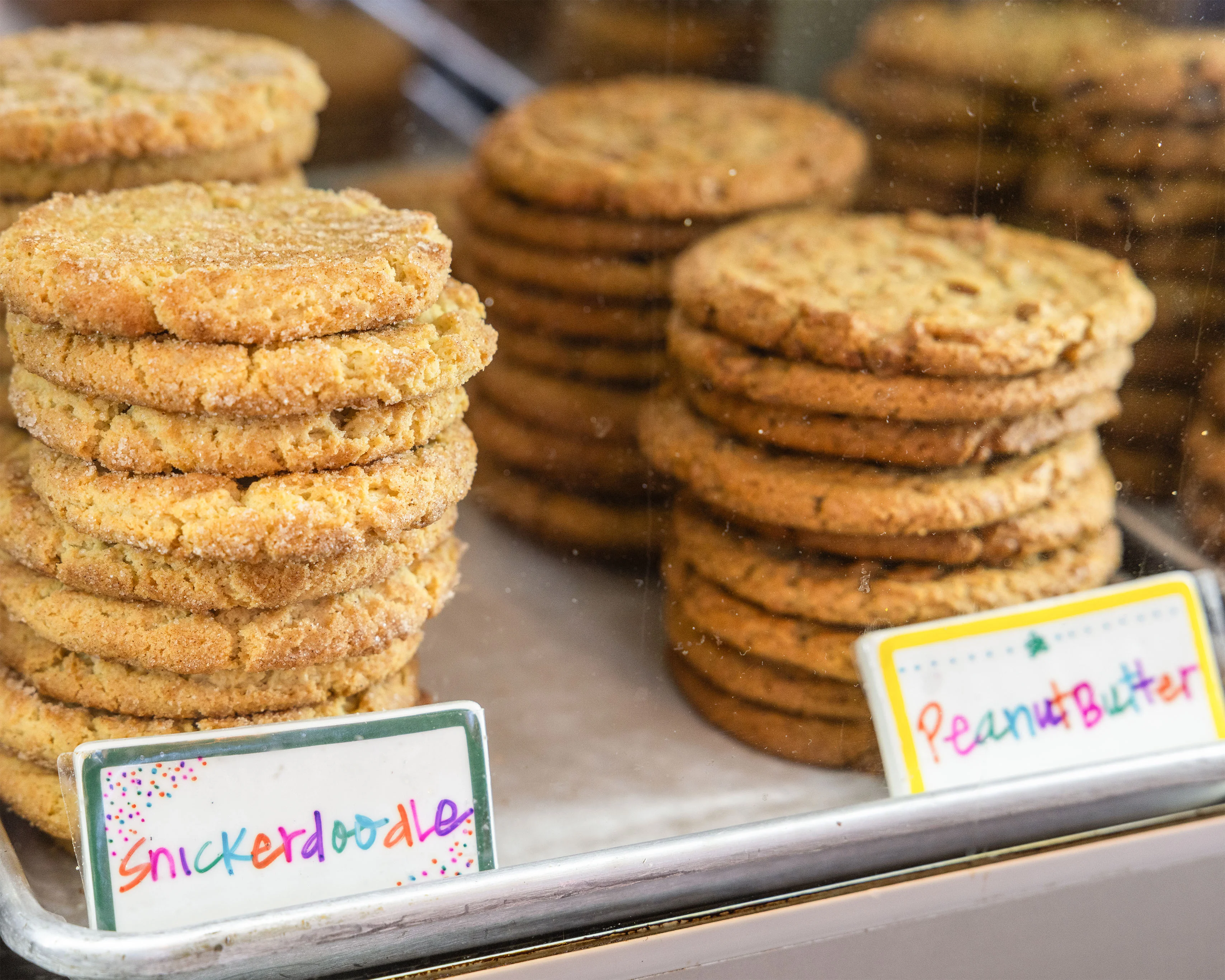 Stacked gingerbread cookies in a bakery display case