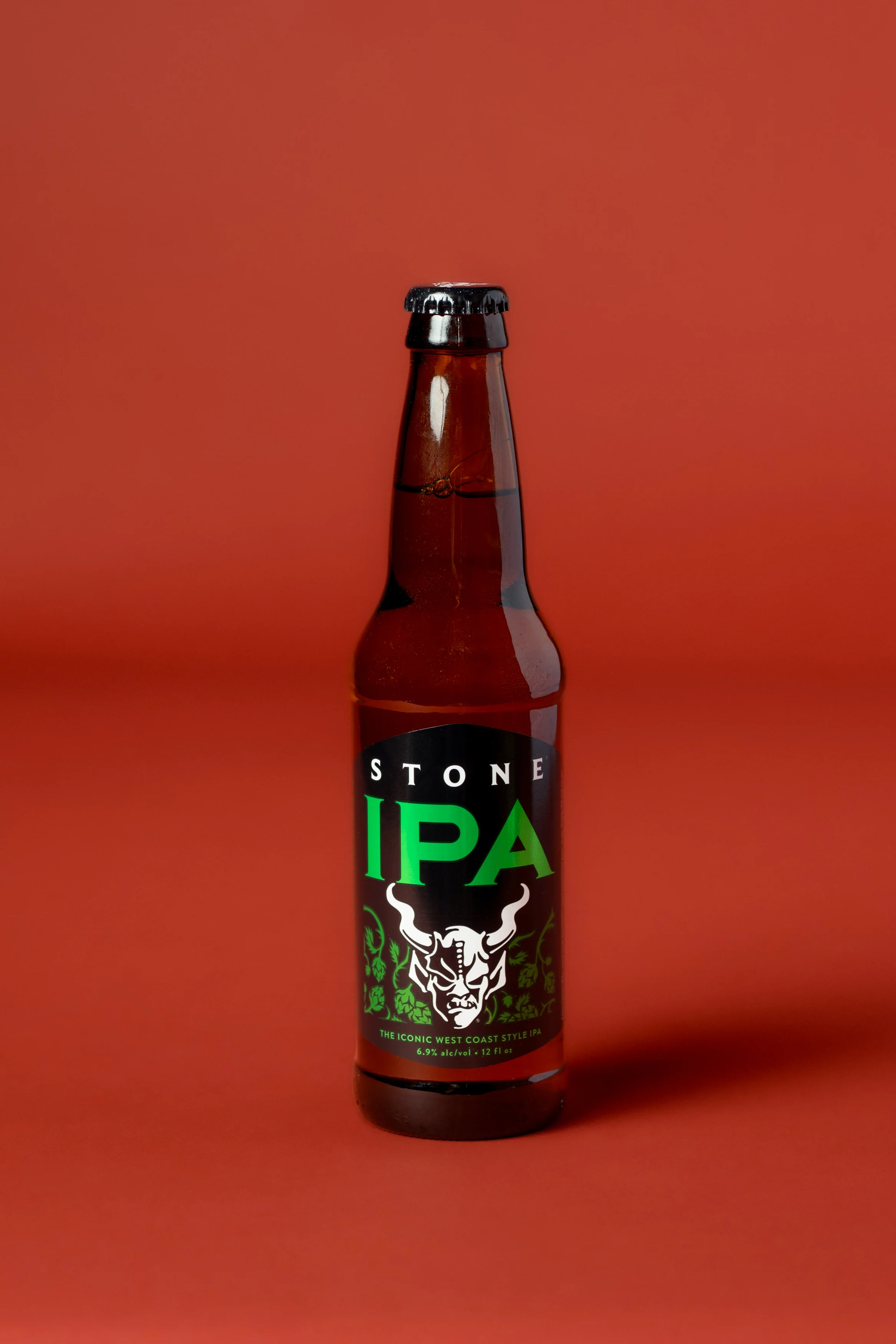 Bottle of Stone IPA beer on a vibrant background