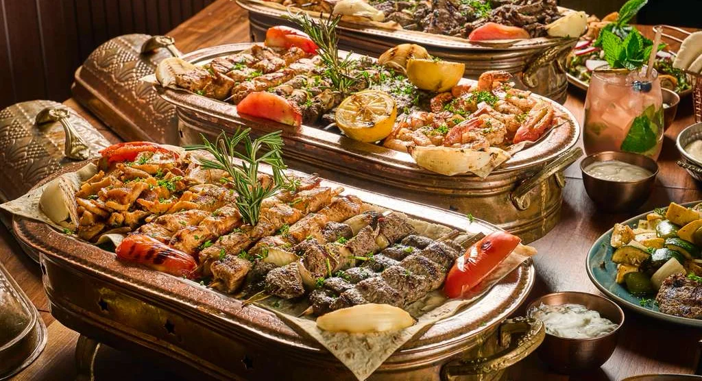 Delicious shawarma platter with fresh vegetables and sauces