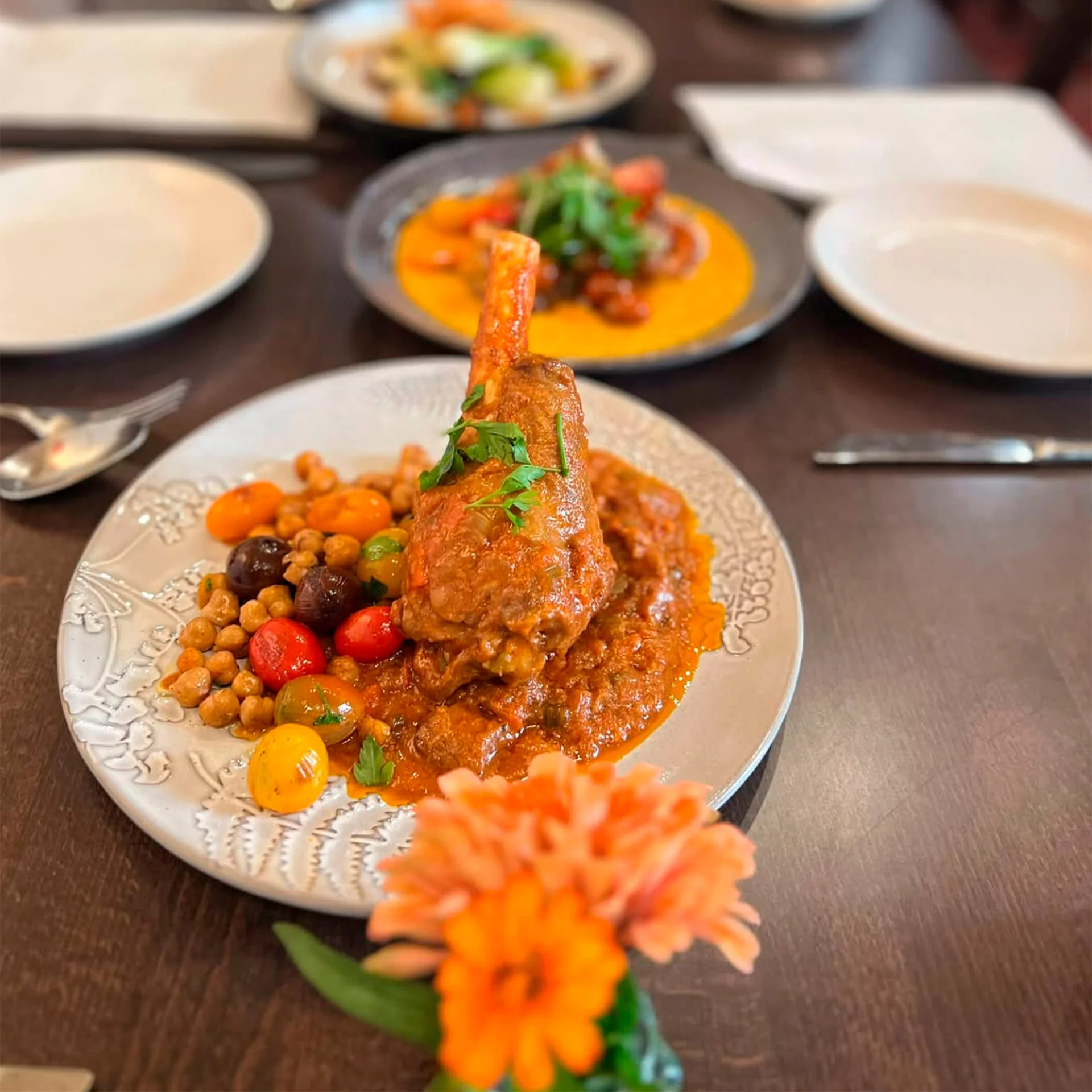 Moroccan lamb tagine served with colorful vegetables