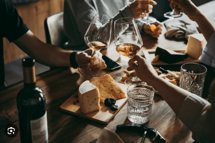 Wine and cheese tasting with friends at a rustic table