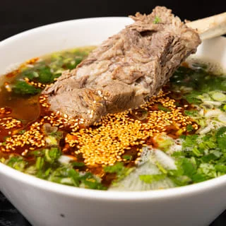 Bowl of Vietnamese pho with beef and herbs