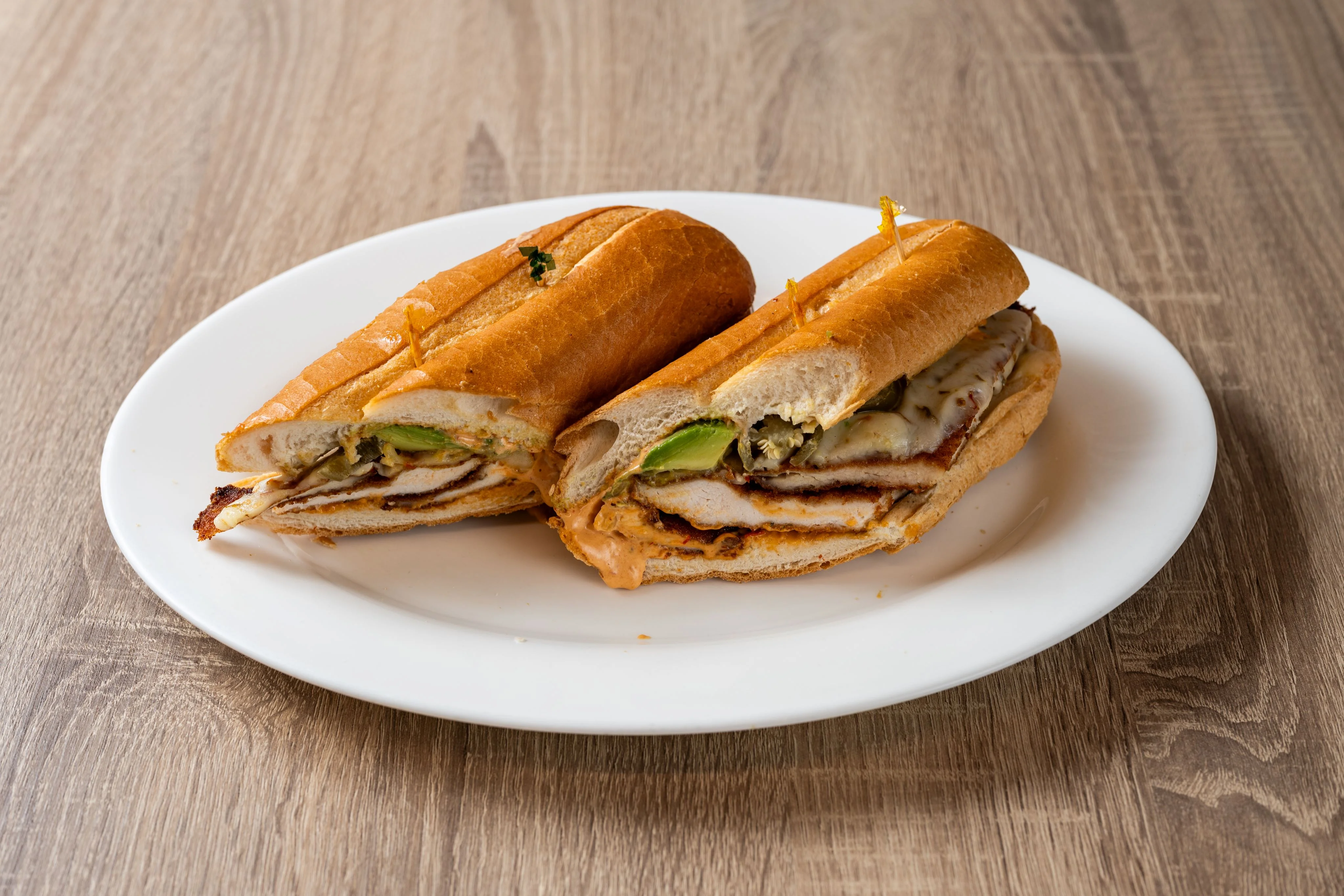 Delicious deli sandwich with fresh ingredients on a wooden table.