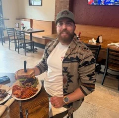 Giant burger with fries in a cozy restaurant setting