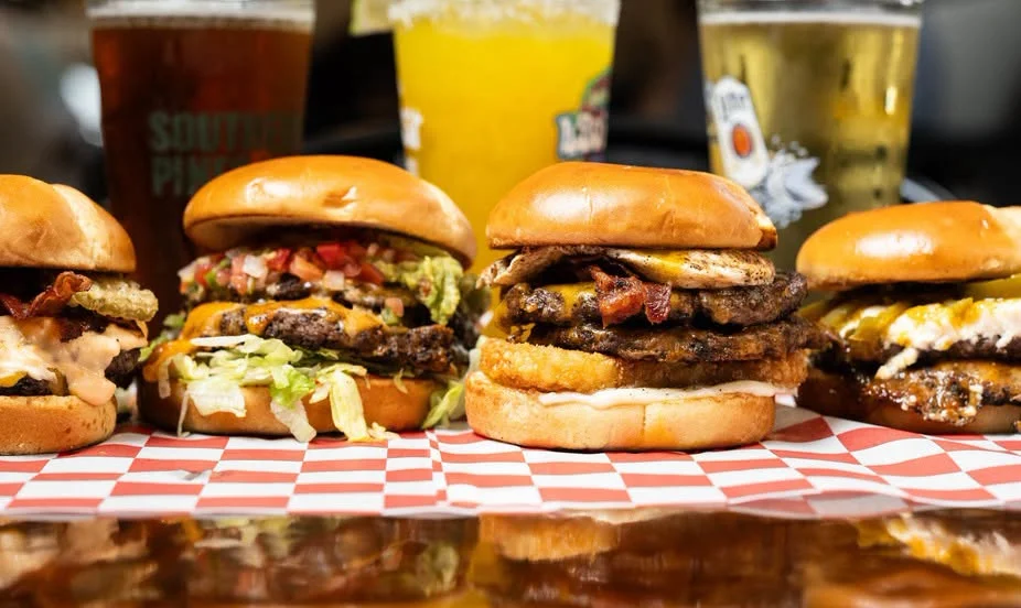 Gourmet burgers with sweet potato fries in a casual dining setting