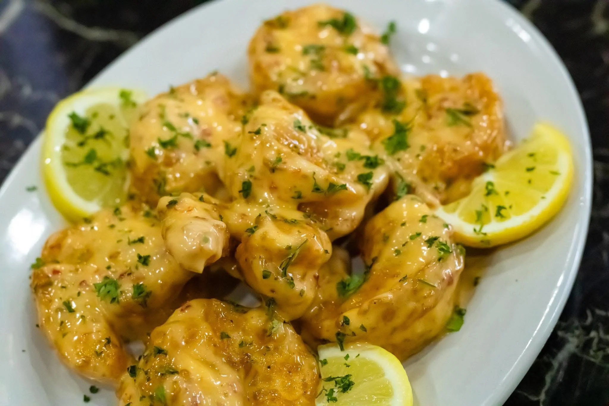 Cajun shrimp in creamy sauce with lemon slices
