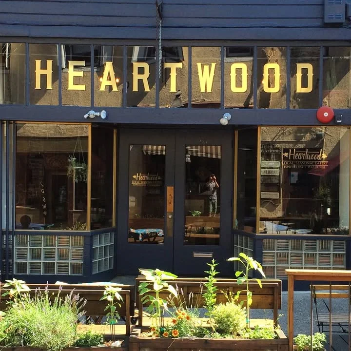 Charming restaurant entrance with wooden decor and plants