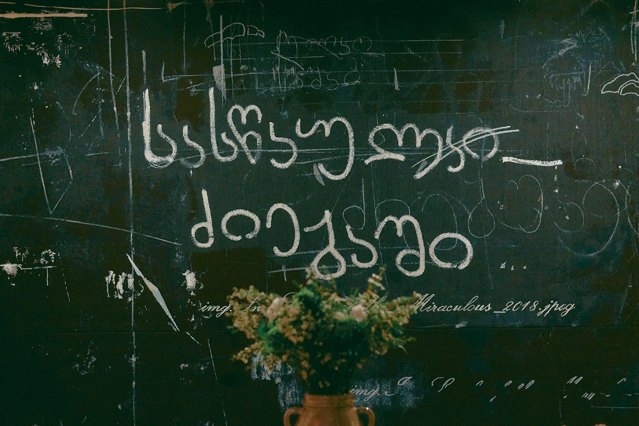 Chalkboard wall with artistic typography and floral arrangement