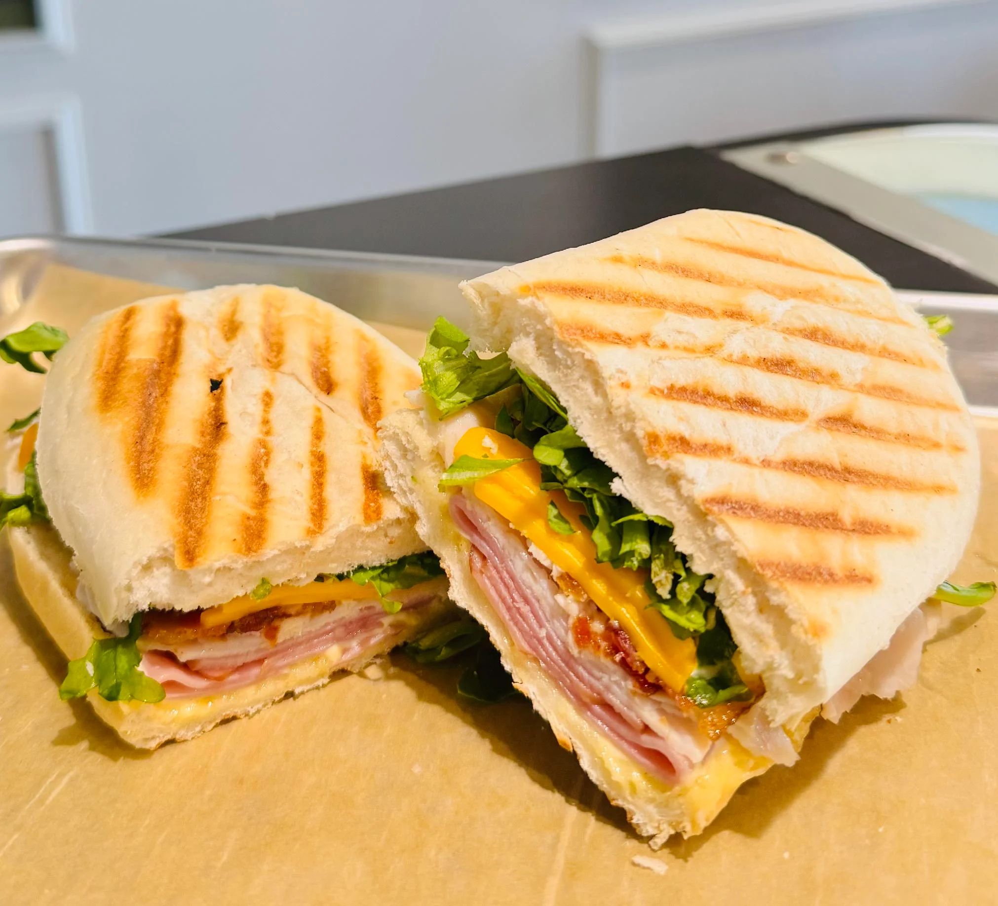 Grilled panini sandwich with ham and cheese