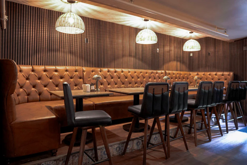 Cozy restaurant interior with leather seating and warm lighting