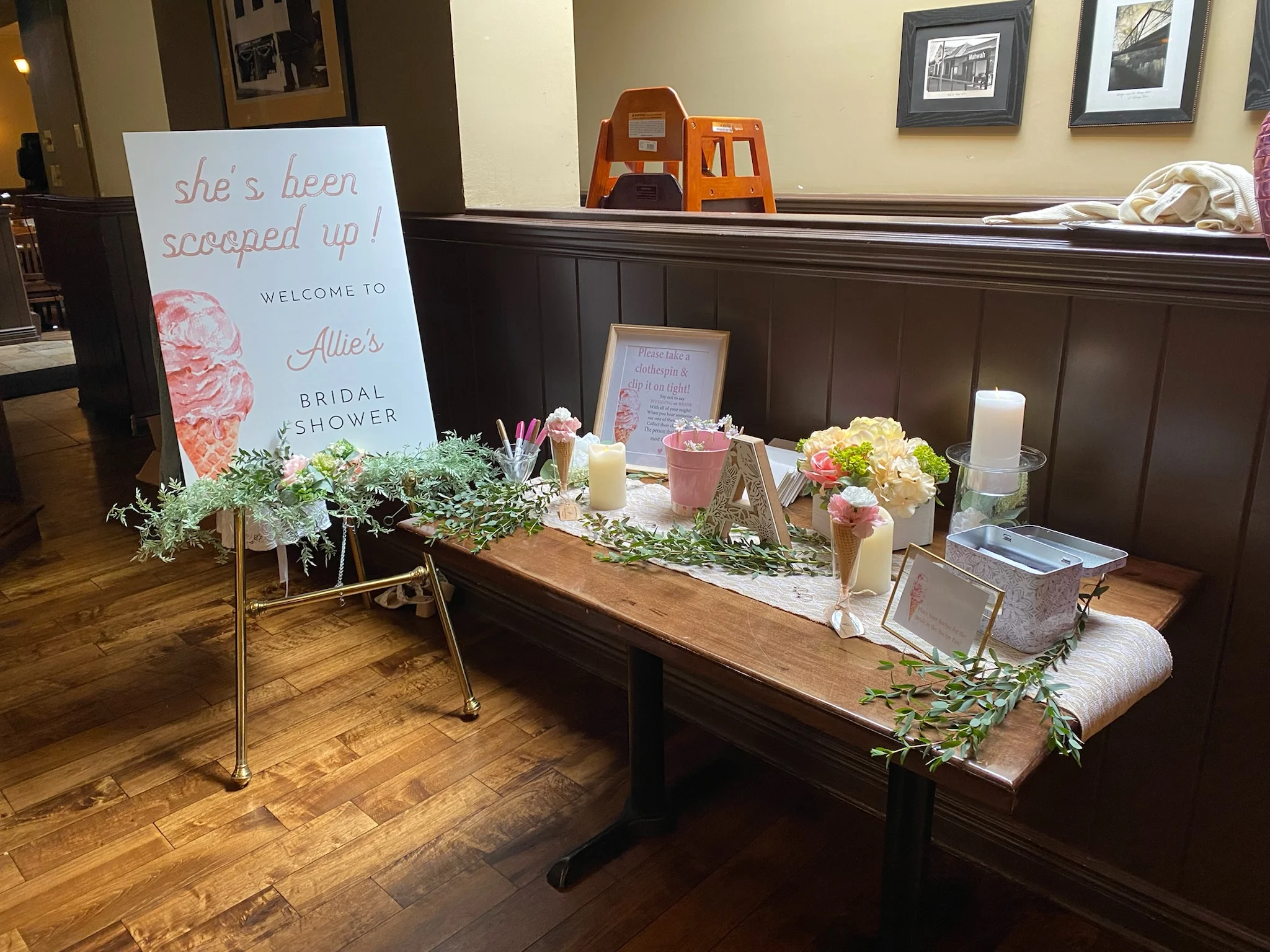 Decorative table for bridal shower with floral arrangements and welcome sign