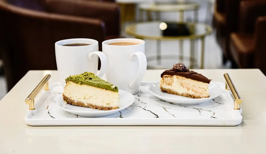 Cheesecake slices with coffee in a modern café setting