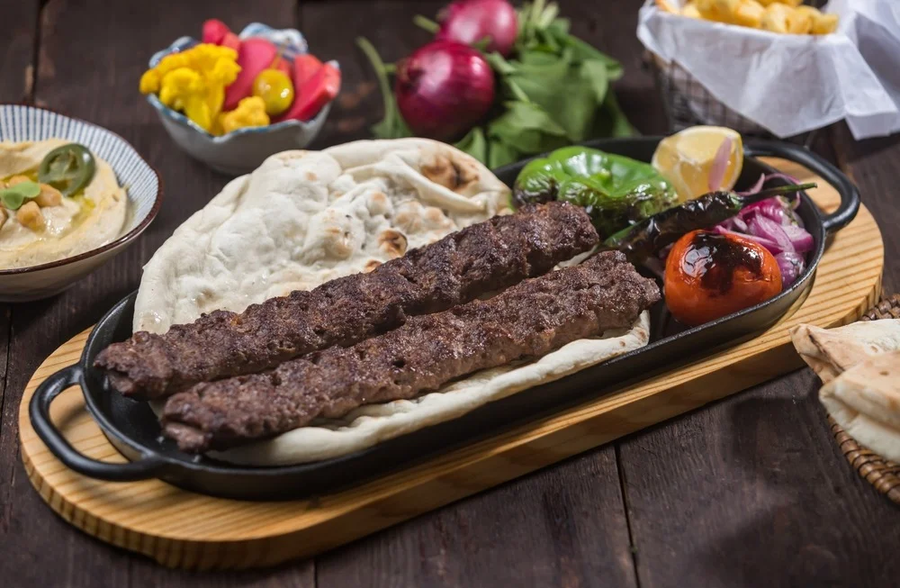 Sizzling kebab platter with naan and grilled vegetables