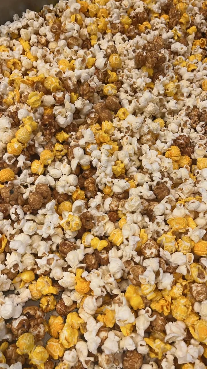 A colorful mix of popcorn in various flavors and colors, spread generously.