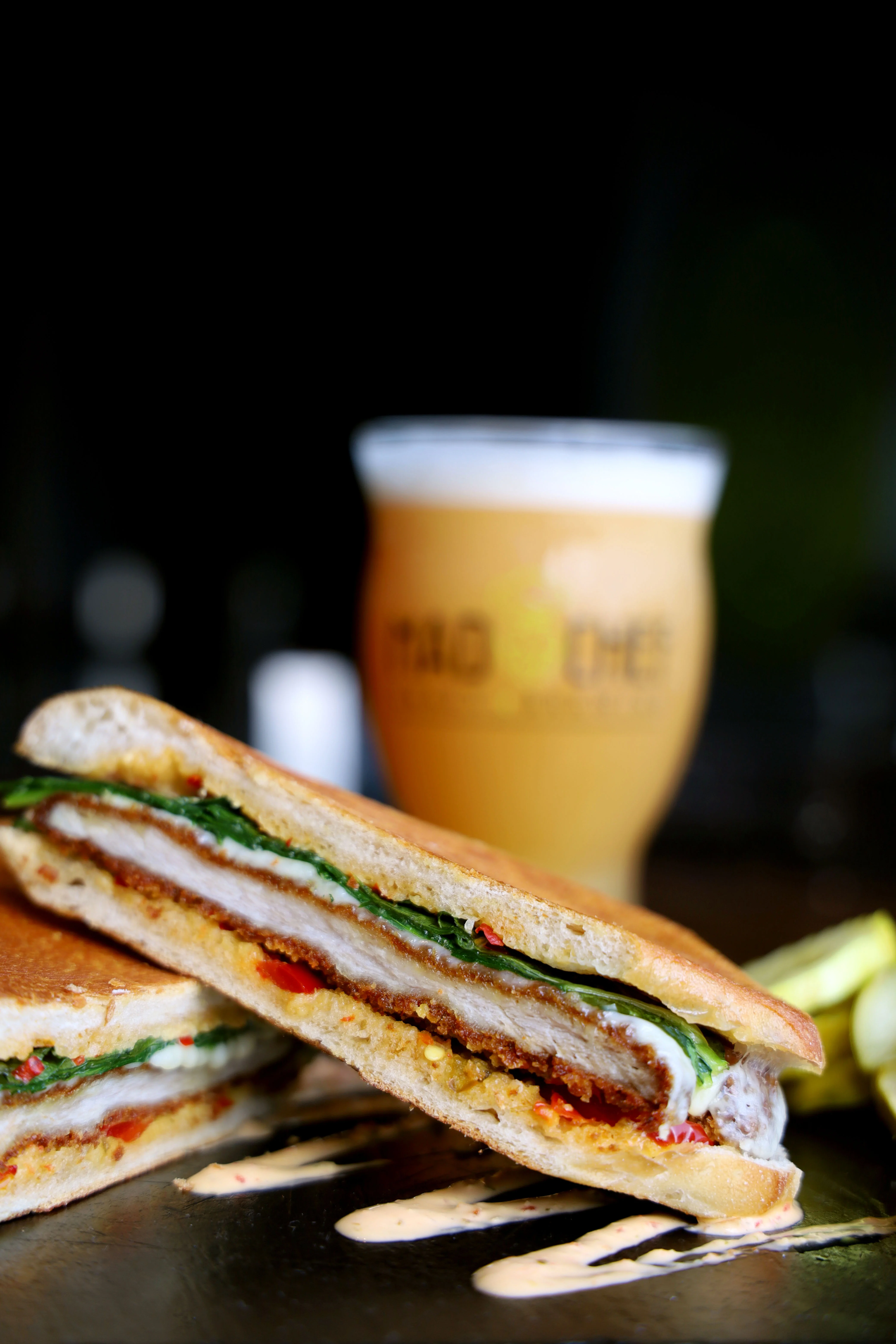 Crispy chicken sandwich with greens and sauce