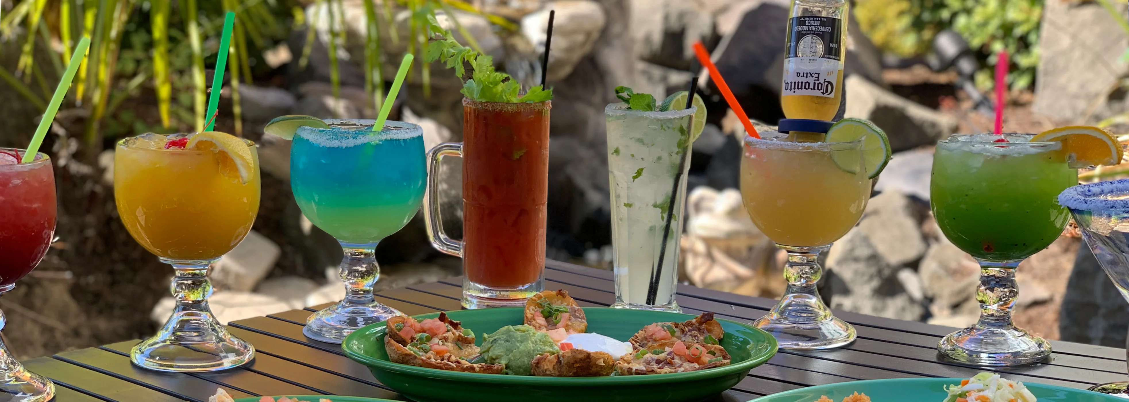 Colorful cocktails and appetizers in a vibrant outdoor setting