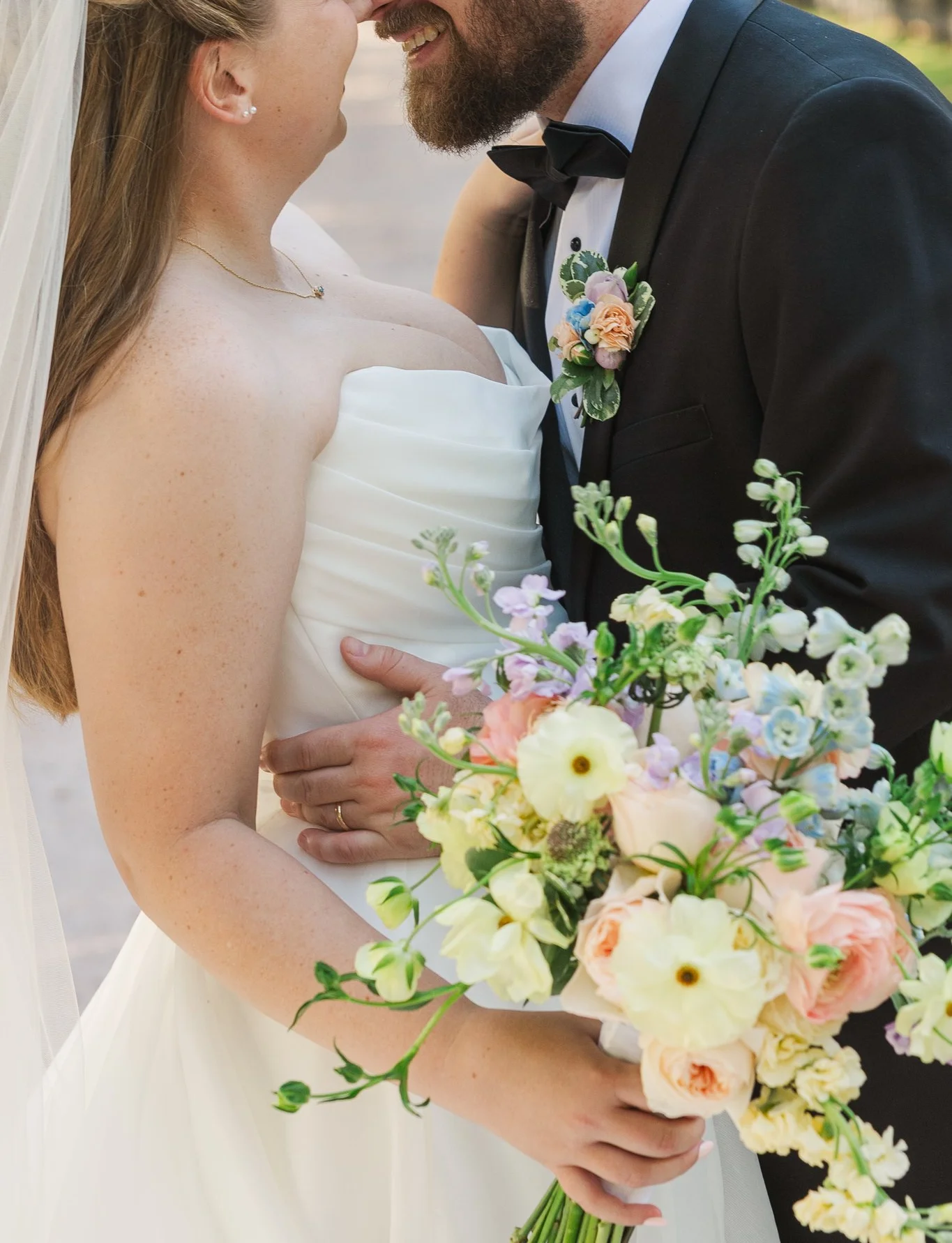 Bride and groom sharing a joyful moment outdoors